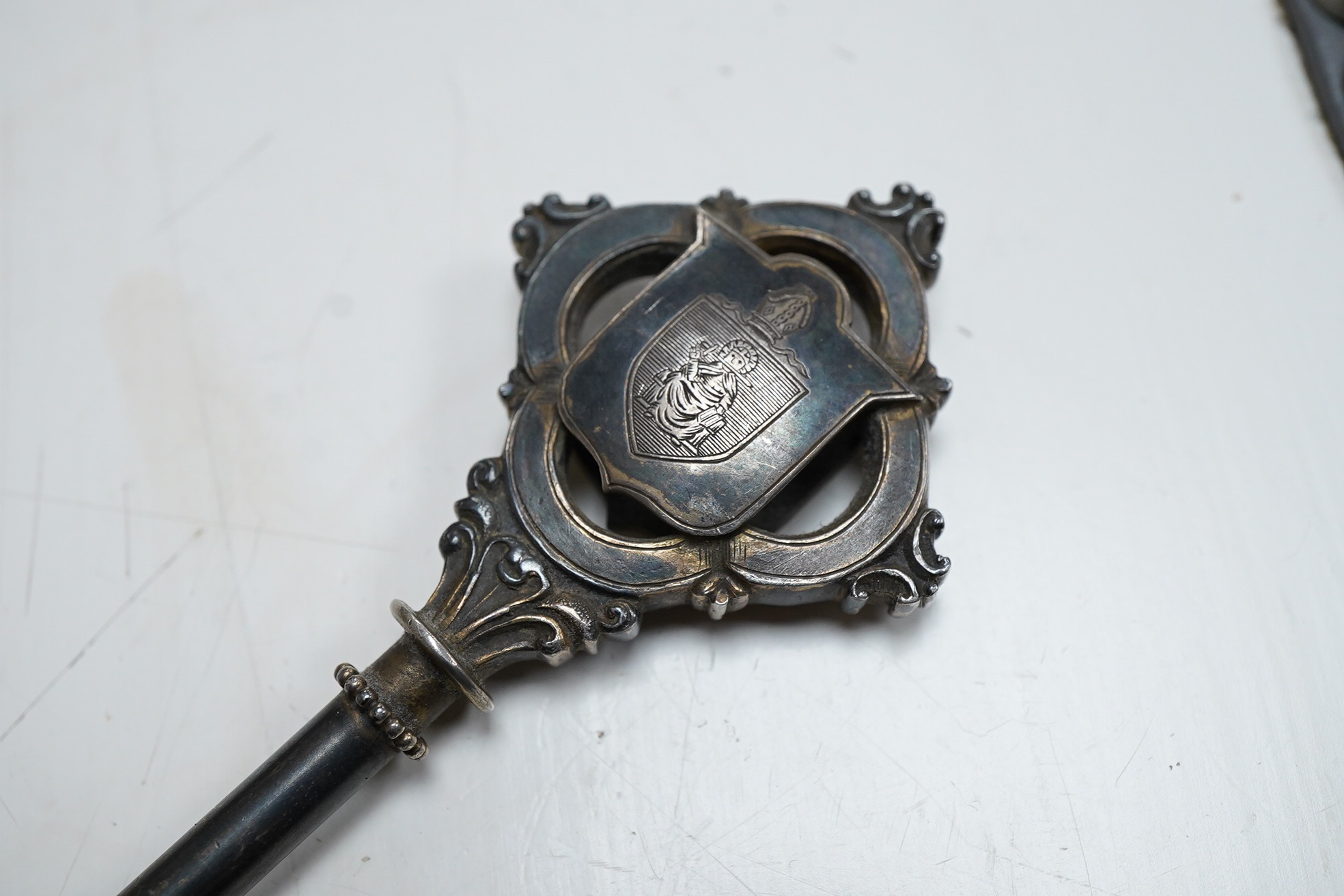 A George V silver presentation? key, engraved with the crest depicting a seated Bishop with mitre above, William James Dingley, Birmingham, 1927, 10.2cm.